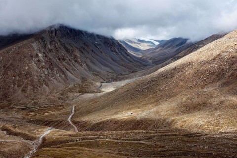 Himalayan landscape with road near Kunzum La pass, allegedly the highest motorable pass in the
