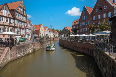 Historic merchant and warehouse houses at the Hanseatic harbour with the sailing ship Willi, Old