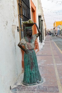Sculpture statue of Mayan woman carrying bowl of fruit on her head, Campeche city, Campeche State,