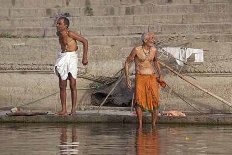 Indian men washing at a ghat along the holy Ganges river, Varanasi, Uttar Pradesh, India, Asia