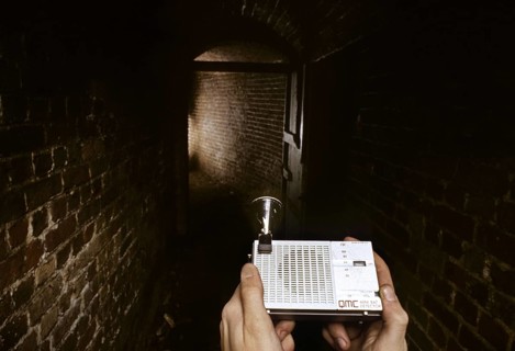 Man using bat detector in old cellar, icehouse for research