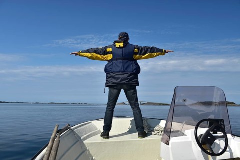 Senior, man on a motorboat on the Atlantic Road in Norway