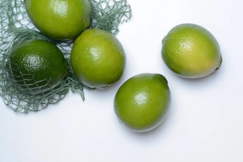 Limes with packing net, citrus fruits