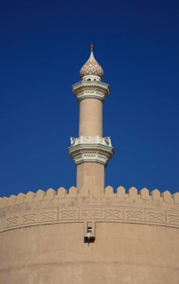 Mosque tower and parapet of the old fort of Nizwa. Nizwa is the centre of the Omani heartland. The