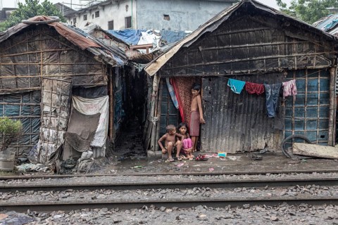 Children in front of their house, which was built right next to the railway tracks, Tejgaon Slum