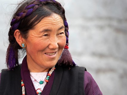 Tibetan woman with braid, laughing, pilgrim in Xigaze, Tibet, China, Asia