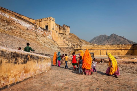 AMER, INDIA, NOVEMBER 18, 2012: Visitors (women in Rajasthani attire) going to Amer (Amber) fort.