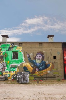 Graffiti sailor in a rubber dinghy, house wall, Munich, Bavaria