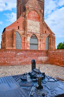 Cast miniature model of St. Mary's Church with the tower of the original in the background,