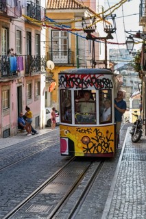Funicular railway, yellow tram, Elevador da Bica, national monument, old residential buildings,