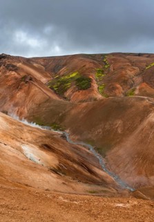 Steaming stream between colourful rhyolite mountains, Hveradalir geothermal area, Kerlingarfjöll,