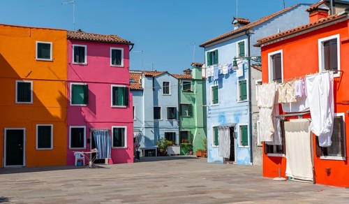 Colourful houses with washing lines, colourful house facades, alleyways on the island of Burano,