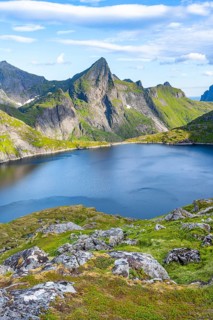 Mountain landscape with lake Tennesvatnet and rocky pointed mountain peak, at sunrise, Moskenesøya,