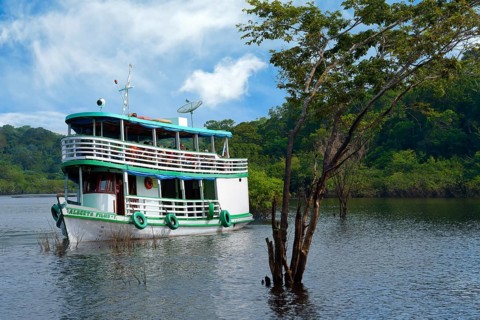 Traditional Amazonian wooden boat navigating on the Rio Negro, Manaus, Amazonia State, Brazil,