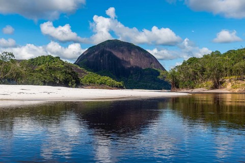 White sand beach before the granite hills of Cerros de Mavecure, Eastern Colombia