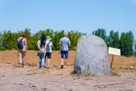 Tourists, Balbals, historical gravestones in the shape of human faces, near Tokmok, Chuy,