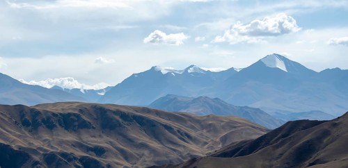 View over eroded mountainous landscape with brown hills, mountains and steppe, Chuy province,