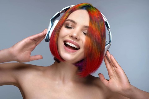 Portrait of beautiful woman with multi-colored hair and creative make up and hairstyle
