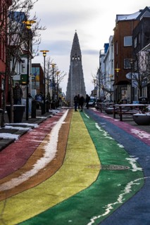 Shopping street Skolavördustigur, painted in the colours of the rainbow, lightly covered with snow,