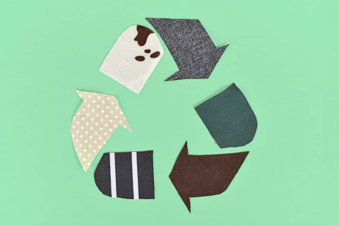 Recycling arrow symbol made from old textile pieces