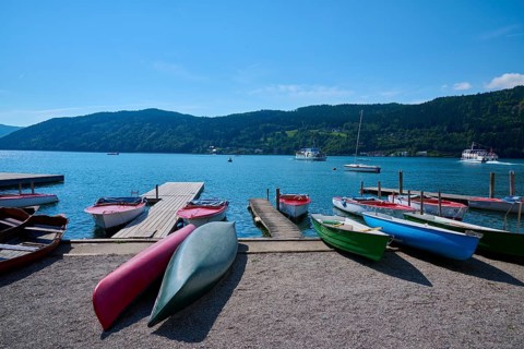 Boats, kayaks, shore, wooden jetty, summer, Lake Millstatt, Millstatt, Carinthia, Austria, Europe