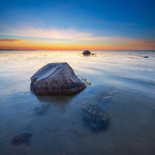 Large boulders on the beach of the Baltic Sea at sunset, Wismar Bay, Baltic Sea,