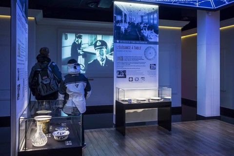 Visitors looking at film and findings brought back up from the Titanic wreck at the Cité de la Mer,