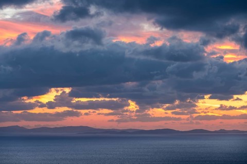 Dramatic cloudy sky at sunrise over the sea, Aegean Sea, Syros, Cyclades, Greece, Europe