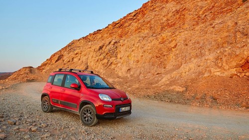 Morning light, red Fiat Panda 4x4, driving track, reddish rock, Gramvoussa peninsula, Pirate Bay,