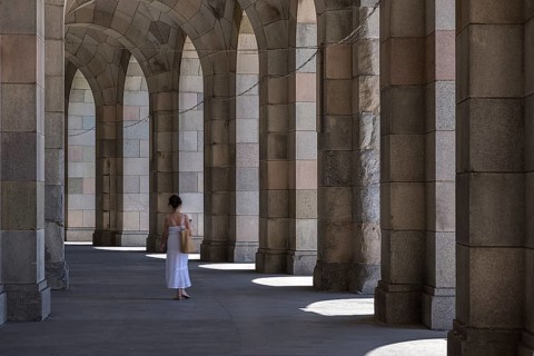 Lady in a white dress in the arcade of the Congress Hall, unfinished National Socialist monumental