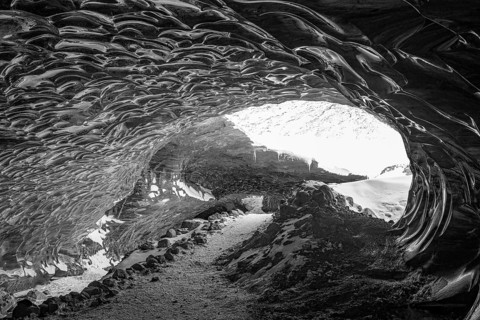 Filigree ice honeycombs at the entrance to the Pröng ice cave, black and white photo, Sudurland,