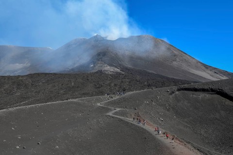 Hikers in the crater landscape of the volcano Etna, summit region, province of Catania, Sicily,