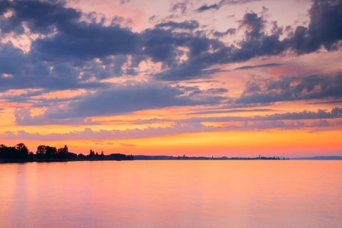 Church and harbour of Romanshorn in the evening light, view from Arbon over Lake Constance