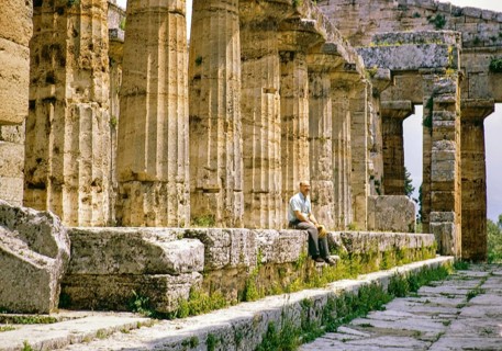 Man sitting inside Temple of Hera II, also known as the Temple of Neptune, Paestum archaeological