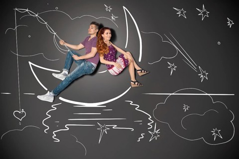 Happy valentines love story concept of a romantic couple fishing on a moon with a heart on a hook