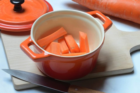 Carrot, carrot sticks in pot and kitchen knife