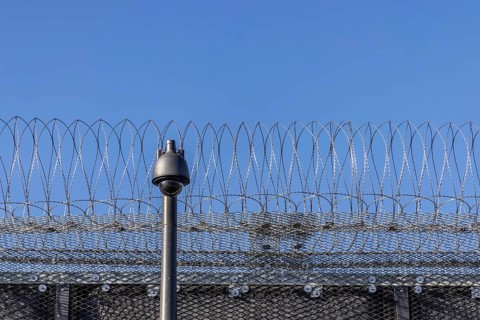 Stammheim prison, JVA. Exterior view with security fence and surveillance camera. Stuttgart,