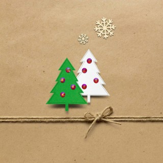 Creative concept photo of paper Christmas trees on a brown background