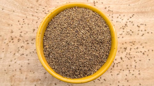 Carom Seeds, Thymol Seeds, Bishop's Weed, Ajwain in a Yellow Bowl, Flat Lay