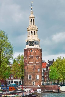 Tower (Montelbaanstoren) on the Bank of the Canal Oudeschans in Amsterdam, Netherlands Amsterdam,