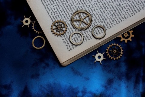 Wooden cogwheels on a page of a book. Industry concept information