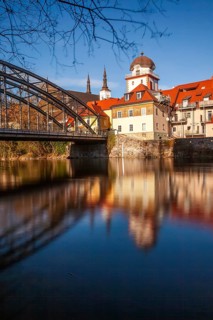 Waasenbrücke and Schwammerlturm, historic old town ensemble reflected in the river Mur, Leoben,