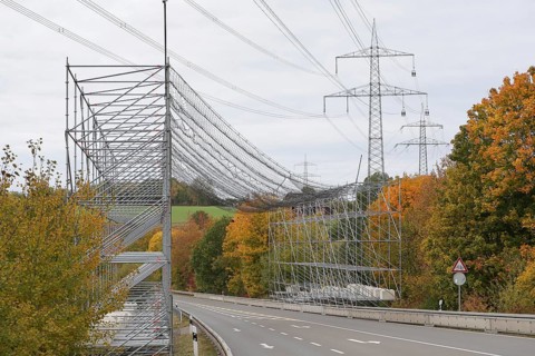 A scaffold with steel net as protection over a road, safety measure due to work on an overhead line
