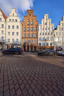 Historic houses, restaurants, facades with windows and gables, street An der Obertrave, Hanseatic