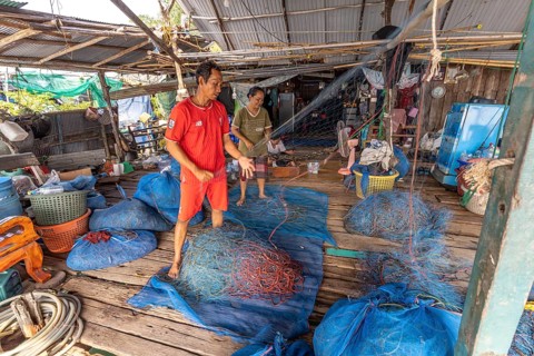 Fishermen repairing their nets, Ban Ao Salad fishing village, Ko Kut island or Koh Kood island in
