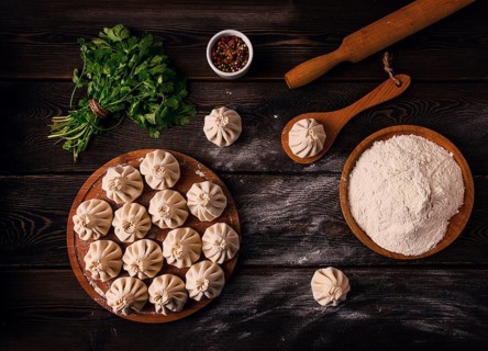 Raw khinkali, Traditional Georgian dish, on a wooden table, selective focus, rustic, no people