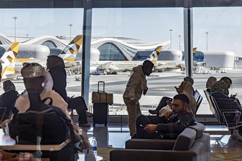 Abu Dhabi Airport. View of the modern terminal with Etihad airline aircraft from the gate. Abu