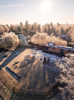 Tipi and caravan in a frosty winter landscape with rays of sunshine, day care centre, Gechingen,