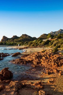 Lonely picturesque beach and red rocks, Spiaggia Su Sirboni, sunrise, near Tertenia, Province of