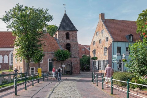 Church tower and old brick buildings, centre of Greetsiel, Krummhörn, East Frisia, Lower Saxony,